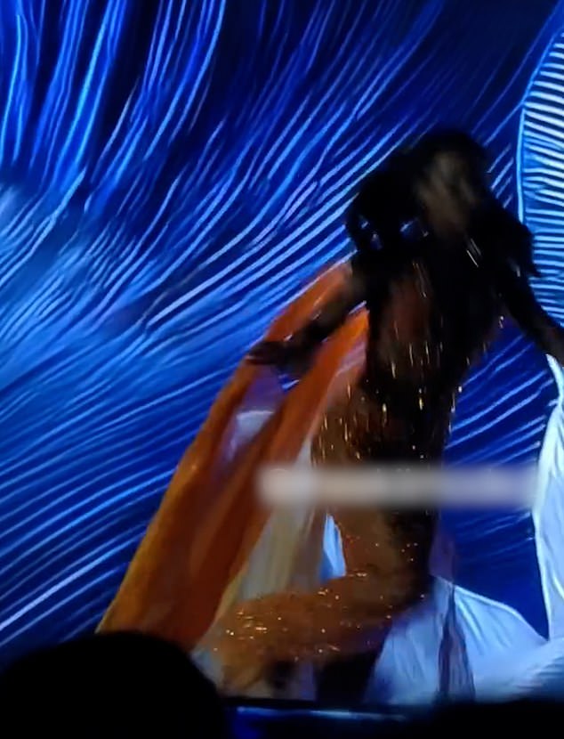 Frame showing Miss Jamaica, Dr. Gabrielle Henry, stepping off the edge of the stage during the Miss Universe preliminaries in Bangkok.