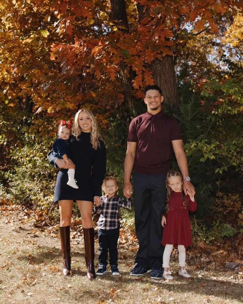 The Mahomes family posing for a Thanksgiving photo outdoors in autumn.