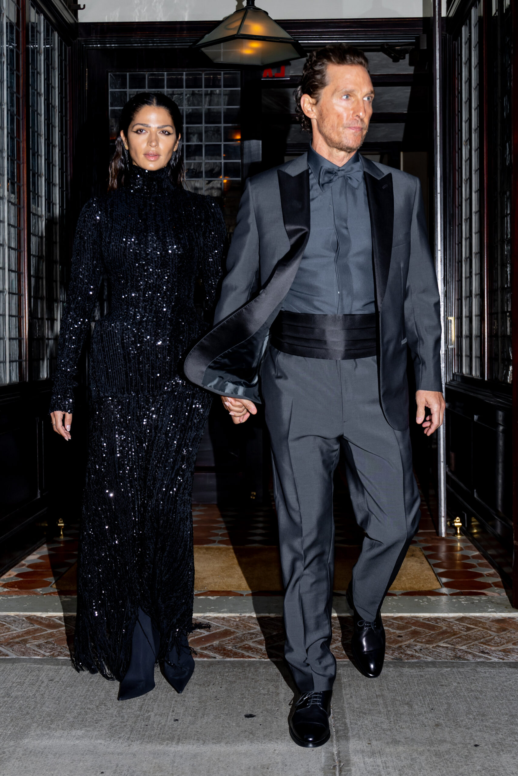 Camila Alves McConaughey in a black sequin dress and Matthew McConaughey in a gray tuxedo.