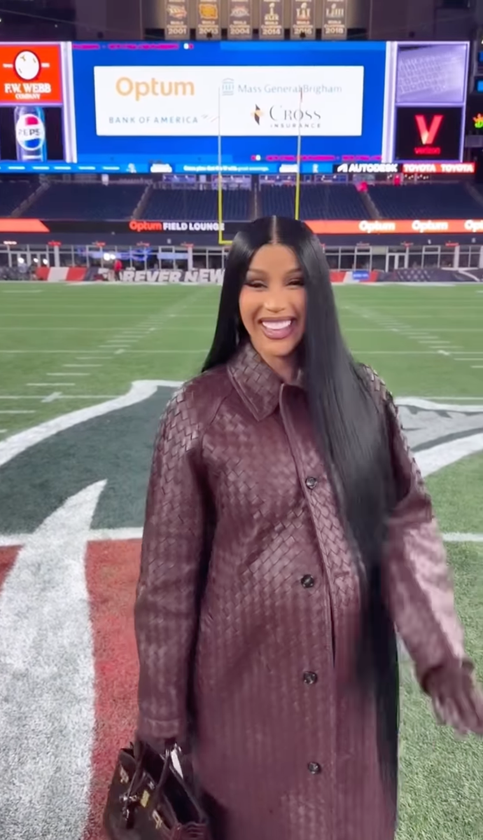 Cardi B, who said on X Spaces that she feels harassed and threatened, pictured on a football field.