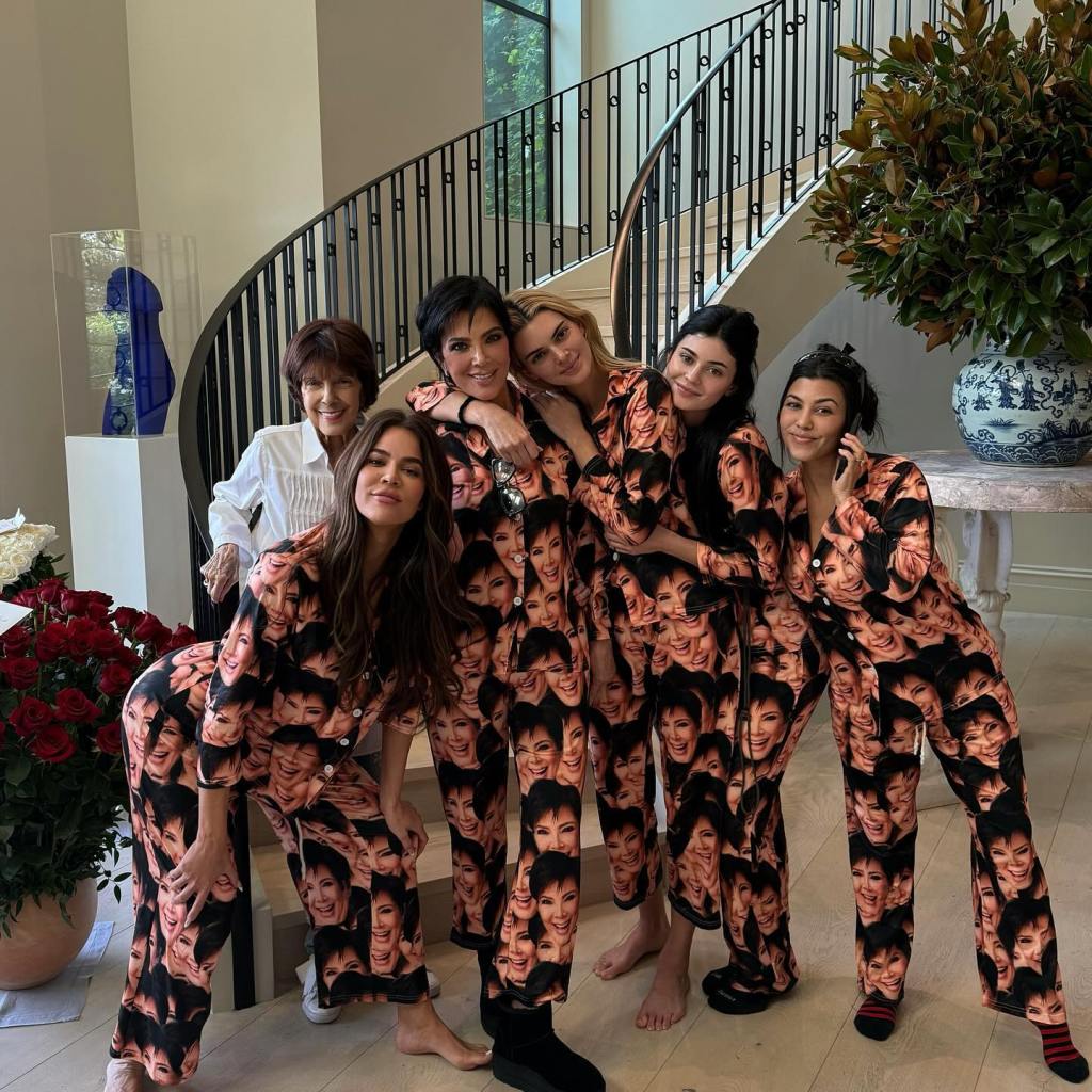 Khloe Kardashian, Kris Jenner, Kendall Jenner, Kylie Jenner, and Kourtney Kardashian posing in matching pajamas.