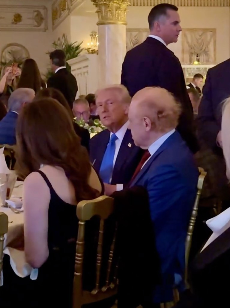 President Donald Trump seated at Mar-a-Lago during the private party hosted by Anthony Pratt.