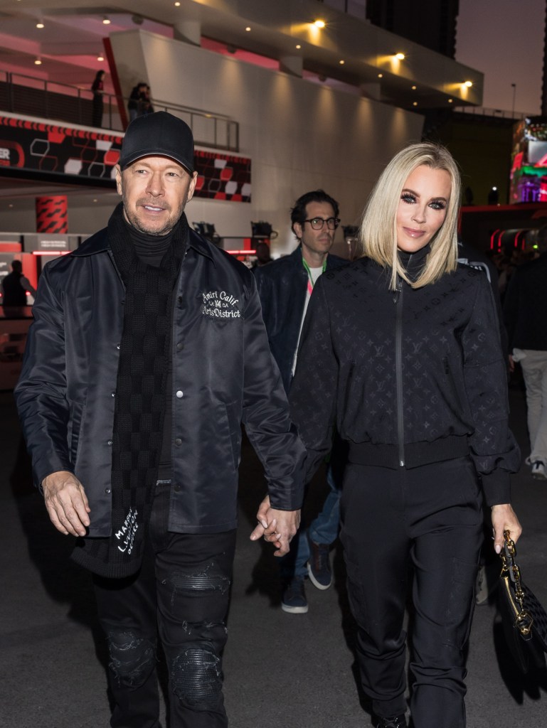 Donnie Wahlberg and Jenny McCarthy hold hands on the red carpet.