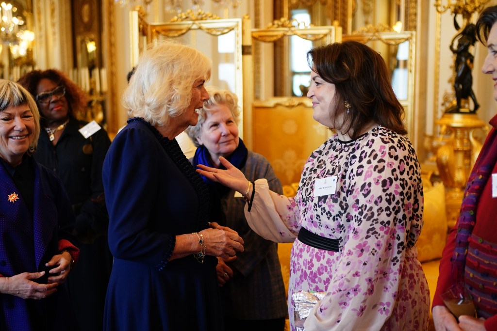 Queen Camilla speaking with Ruth Jones at a Women of the World reception at Buckingham Palace.