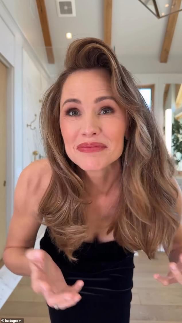 Jennifer Garner opens the video in a strapless black gown, full glam.