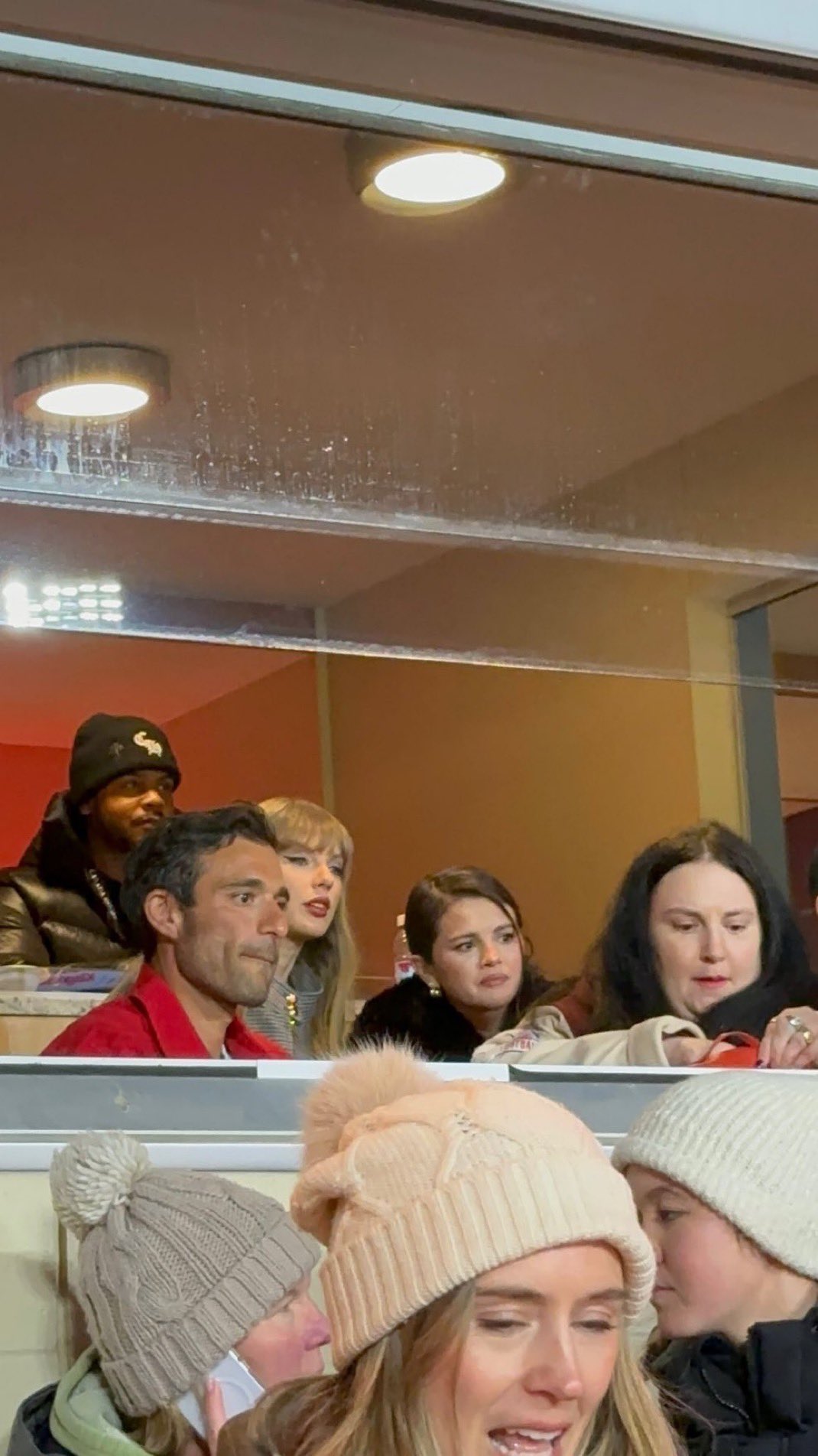 Taylor Swift and Selena Gomez watch from a private suite at Arrowhead Stadium during the Chiefs-Texans game.