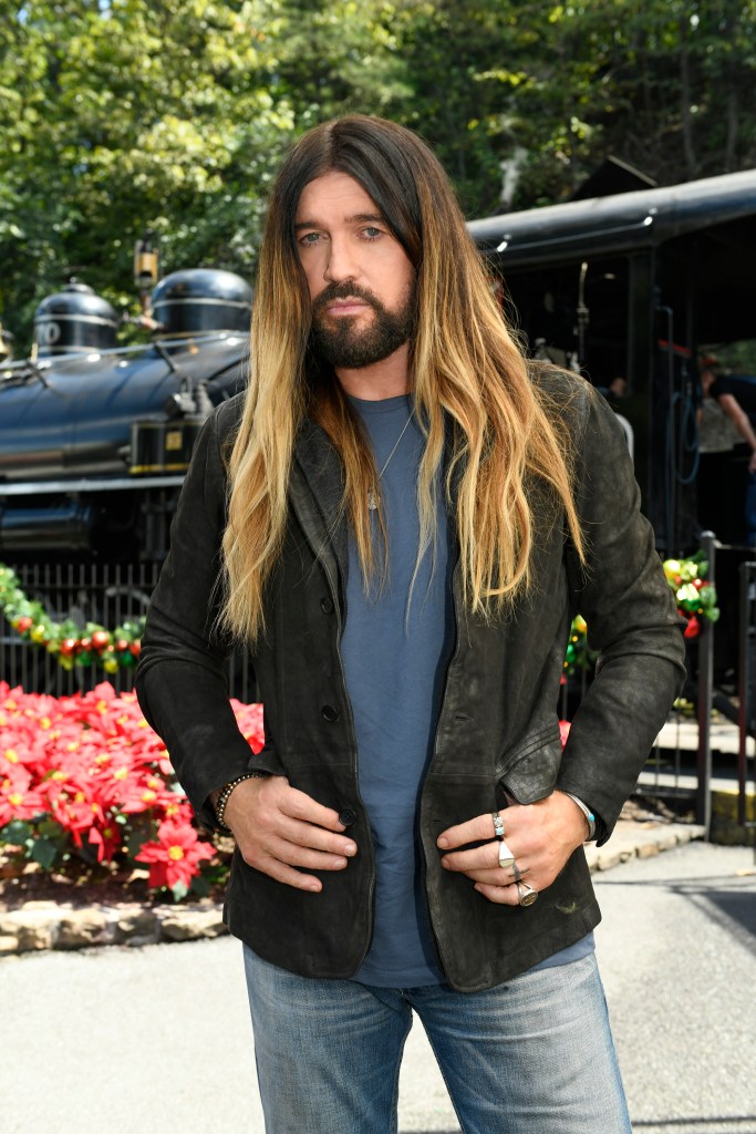 Billy Ray Cyrus wearing a dark jacket and blue shirt.