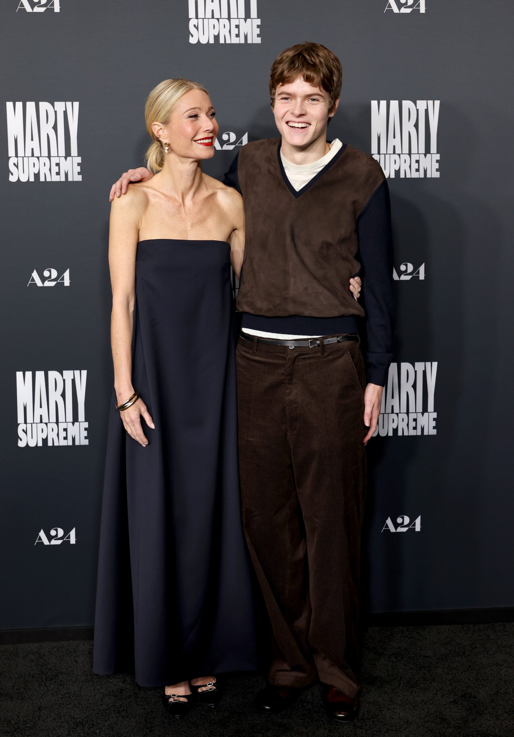 Gwyneth Paltrow and Moses Martin share a laugh with arms around each other at the Samuel Goldwyn Theater premiere.