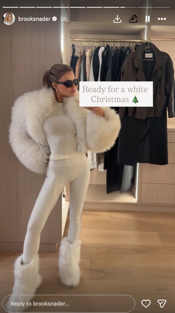 Brooks Nader shows an all-white winter outfit in an Aspen mirror selfie.