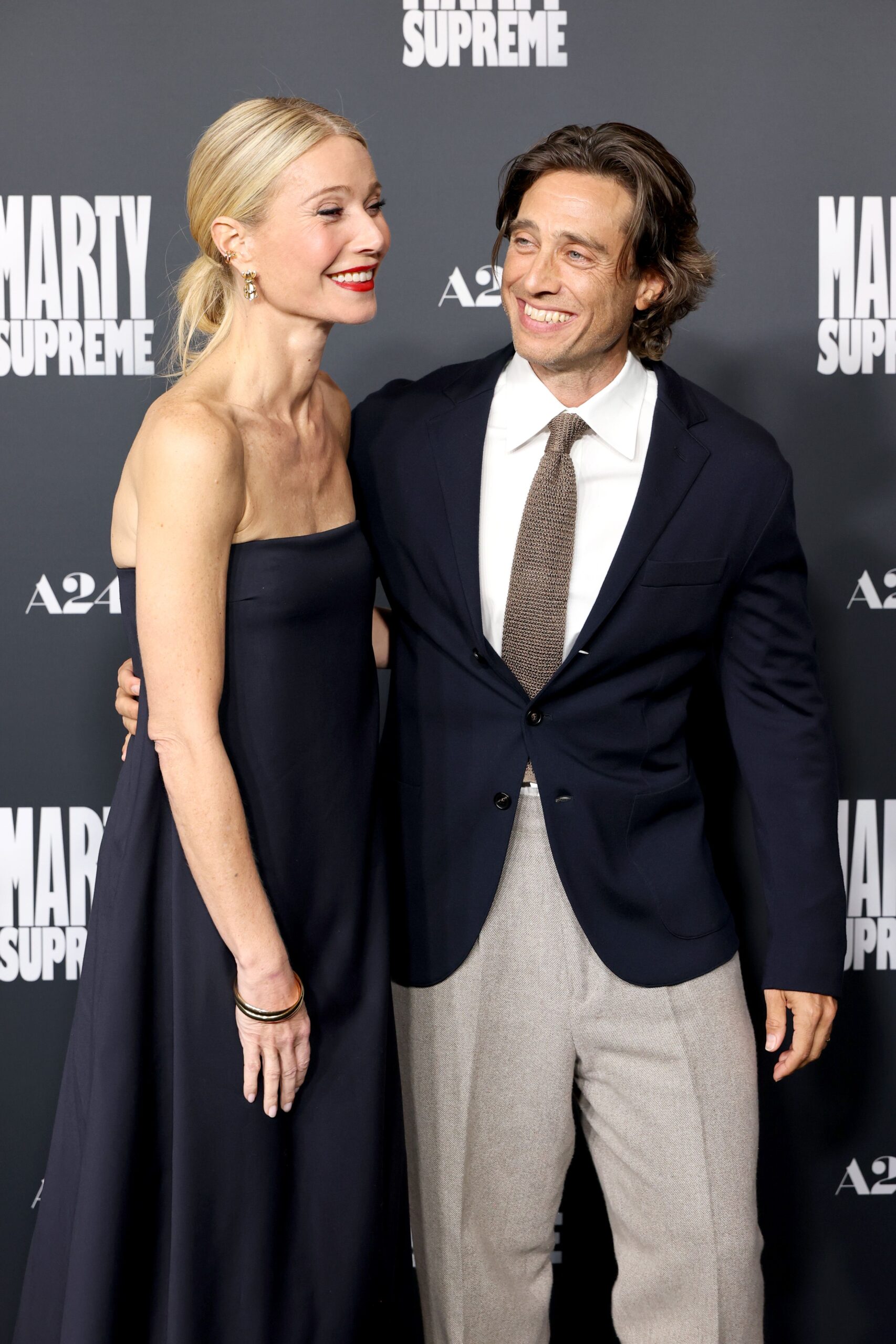 Gwyneth Paltrow and husband Brad Falchuk pose together on the 'Marty Supreme' red carpet in Los Angeles.