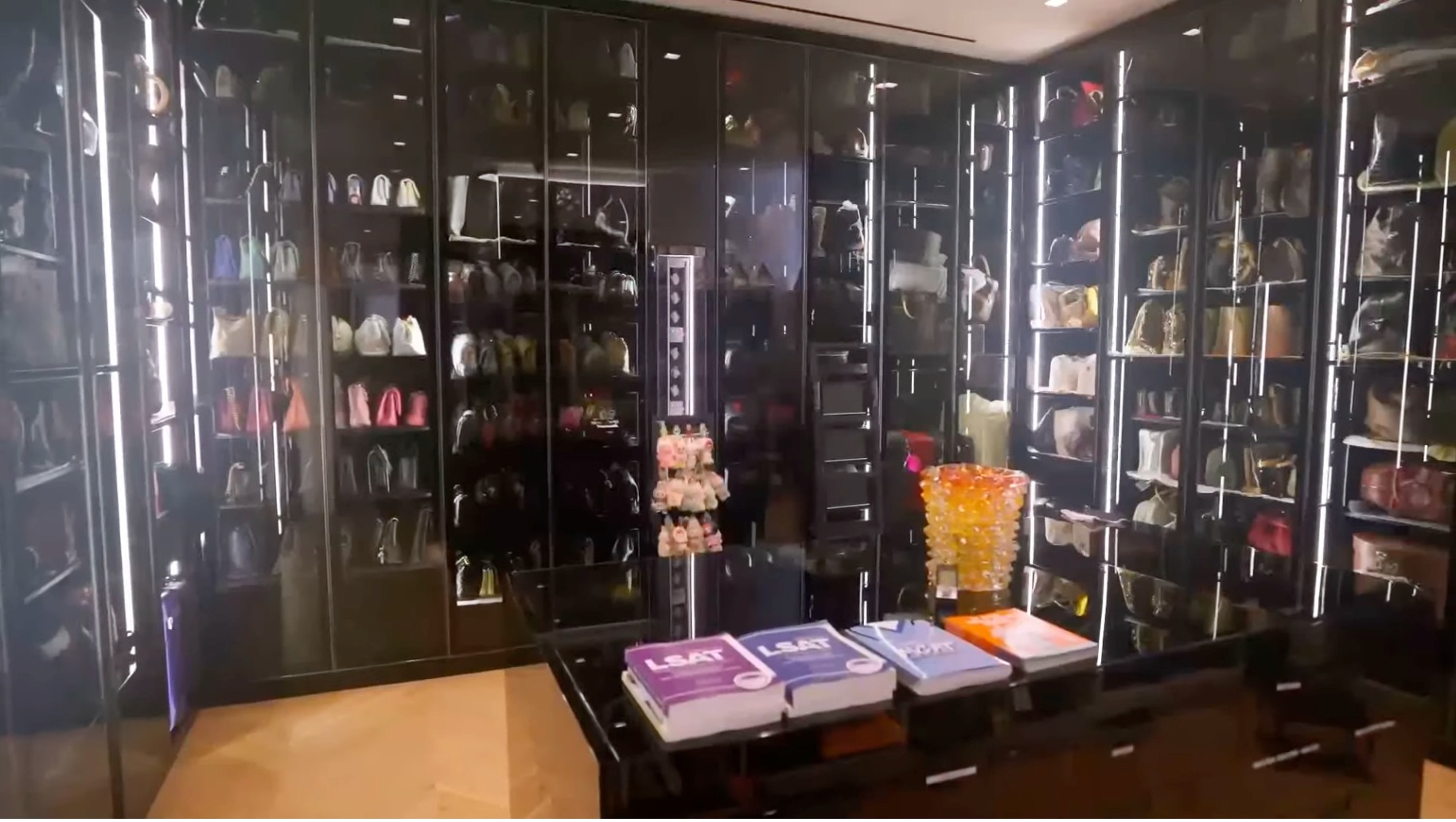 Handbag shelves organized by color, style and designer in Kimora Lee Simmons' closet.