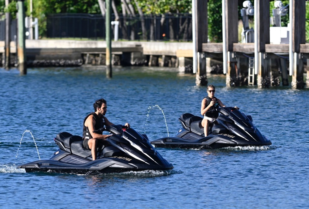 Gisele Bundchen and Joaquim Valente ride separate jet skis off Surfside, Florida.