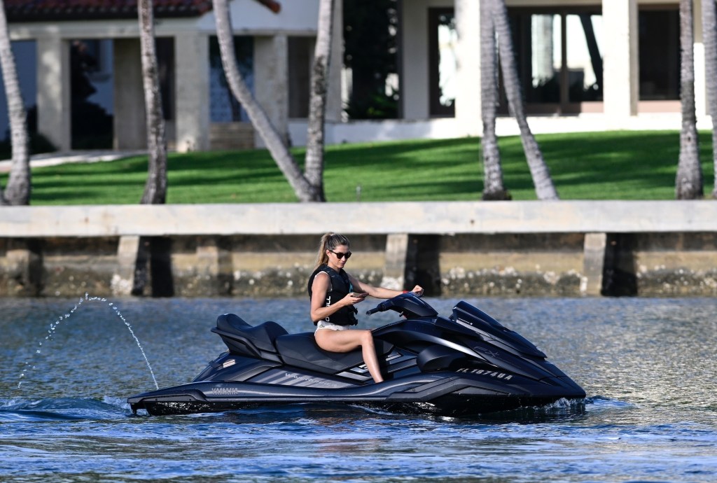 Gisele Bundchen jet skis in a white one-piece during a daytime outing in Surfside.