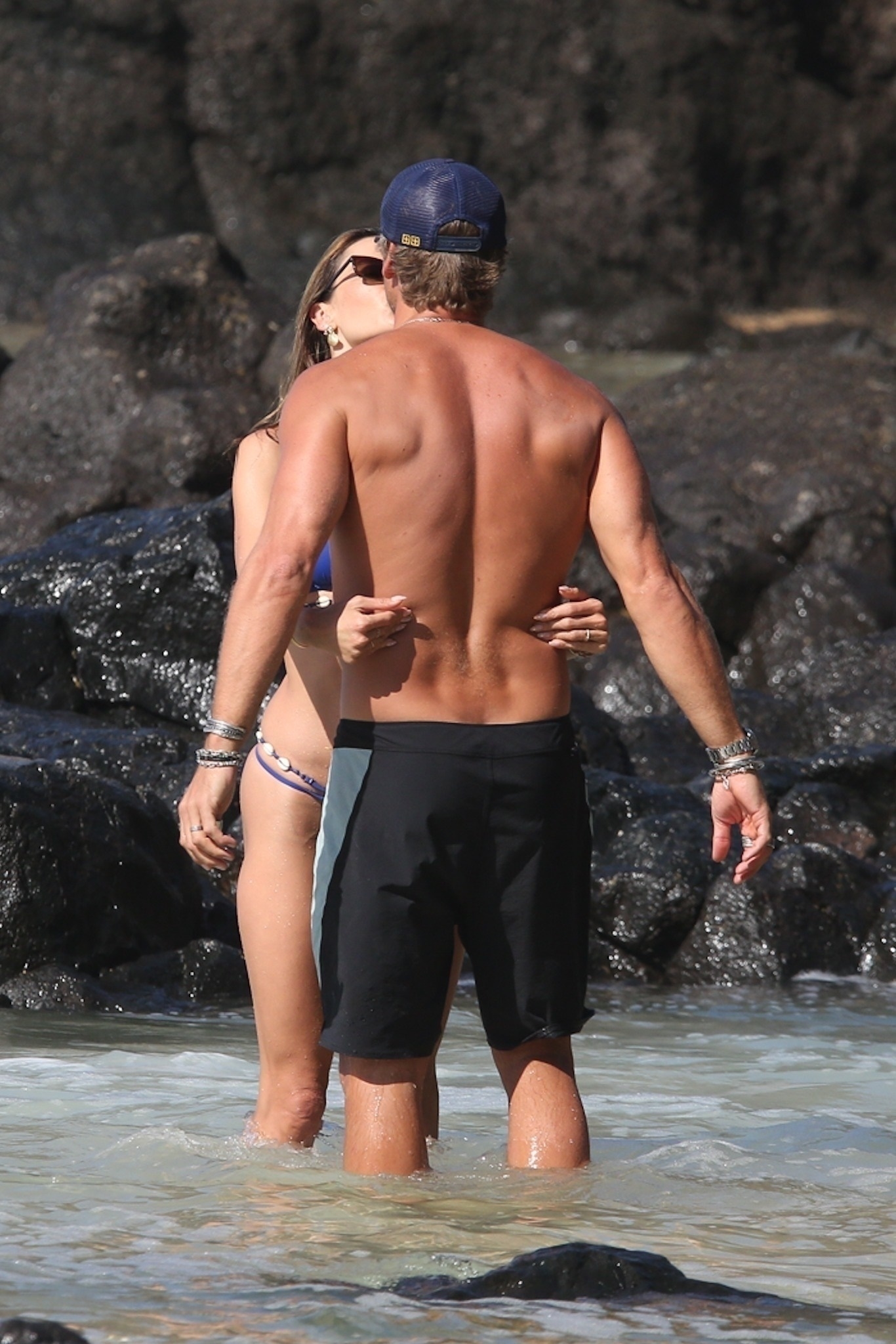 Alessandra Ambrosio and Buck Palmer share a kiss in the shallow water at Boda Beach.