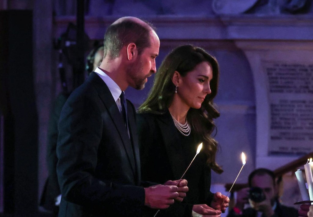 Prince William and Catherine holding lit candles during a Holocaust Memorial Day service at London's Guildhall.
