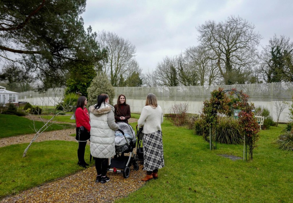 Catherine, Princess of Wales, speaking with three women next to a stroller, reflecting her focus on early childhood support.