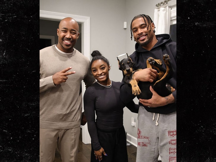 Simone Biles and Jonathan Owens with their new Doberman puppy from Regal Empire Dobermans.