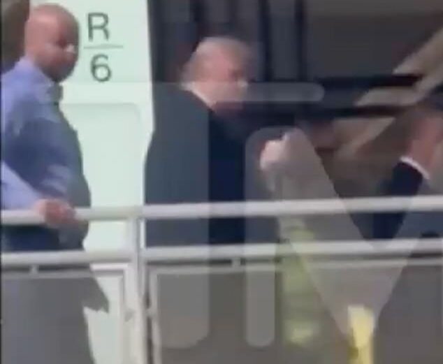 Donald Trump flashes his middle finger toward a heckler during a visit to a Ford factory in Michigan