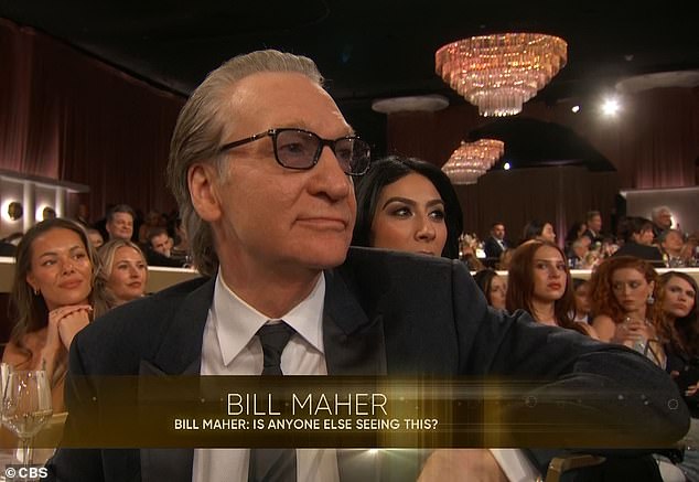 Bill Maher reacts with a stony expression after Wanda Sykes' joke at the Golden Globes