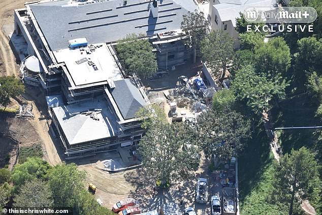 Construction vehicles and crews crowd the hilltop site during the extensive renovation.