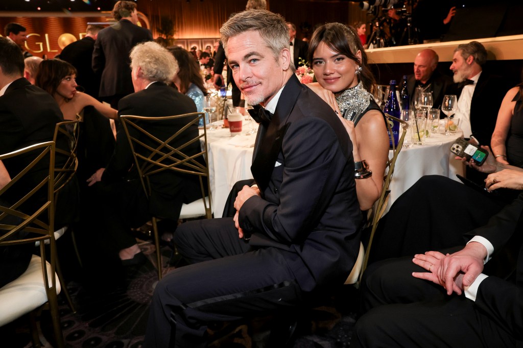Chris Pine and Keyana Sky Wenger seated together inside the Golden Globes ceremony.