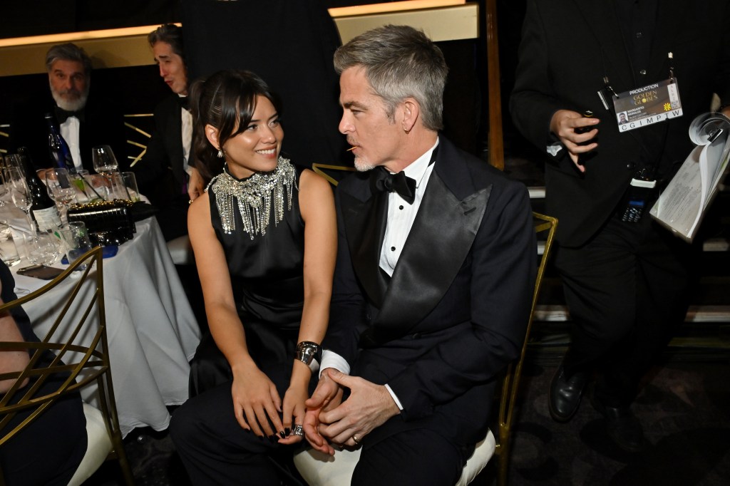 Chris Pine and Keyana Sky Wenger linking arms at the Golden Globes.
