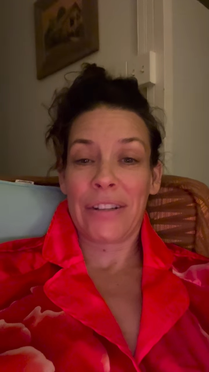 Evangeline Lilly speaking to the camera in a red shirt during her Instagram update.