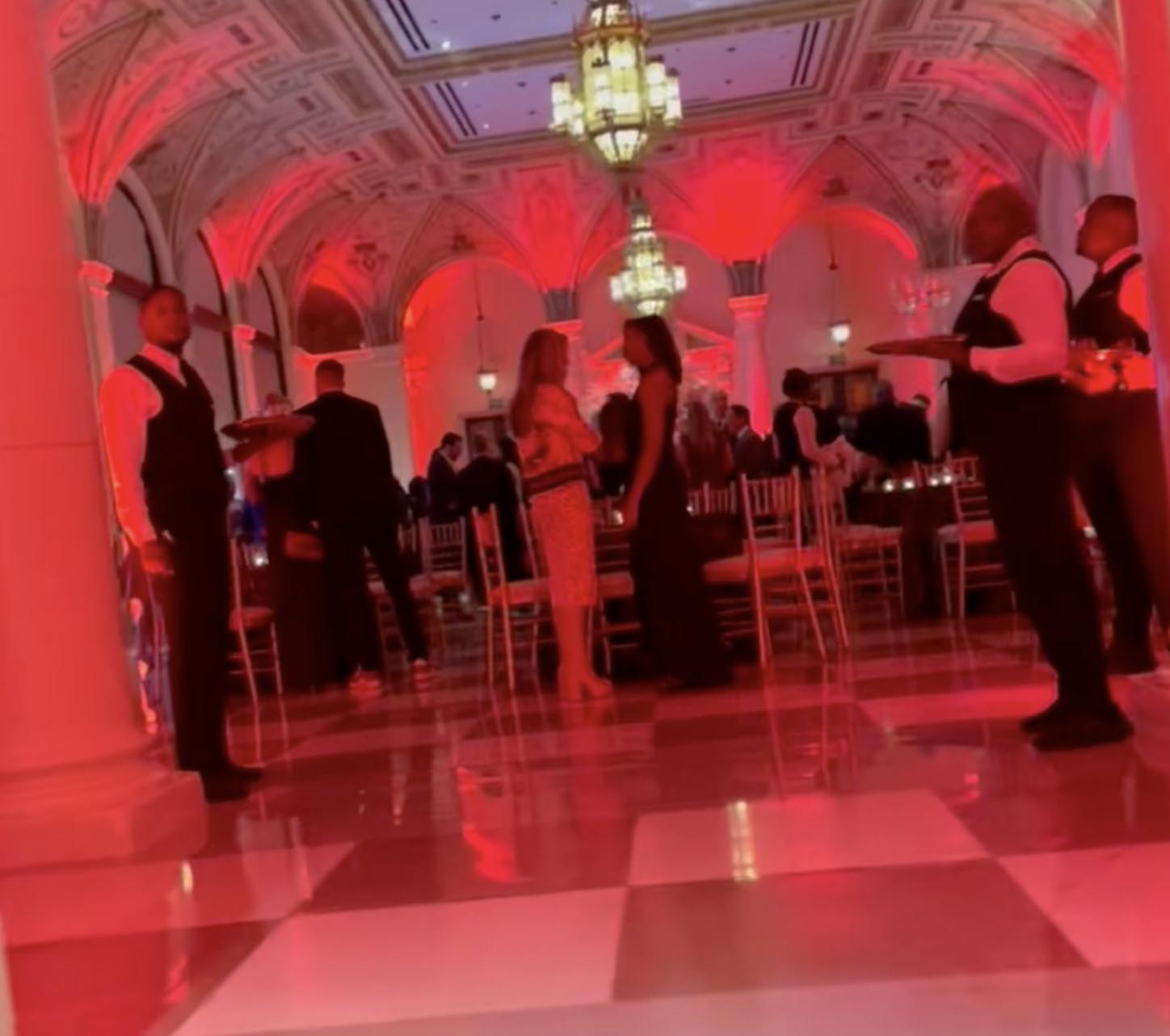 Ballroom at The Breakers with red lighting and checkered floors during Tiger Woods' 50th birthday party.