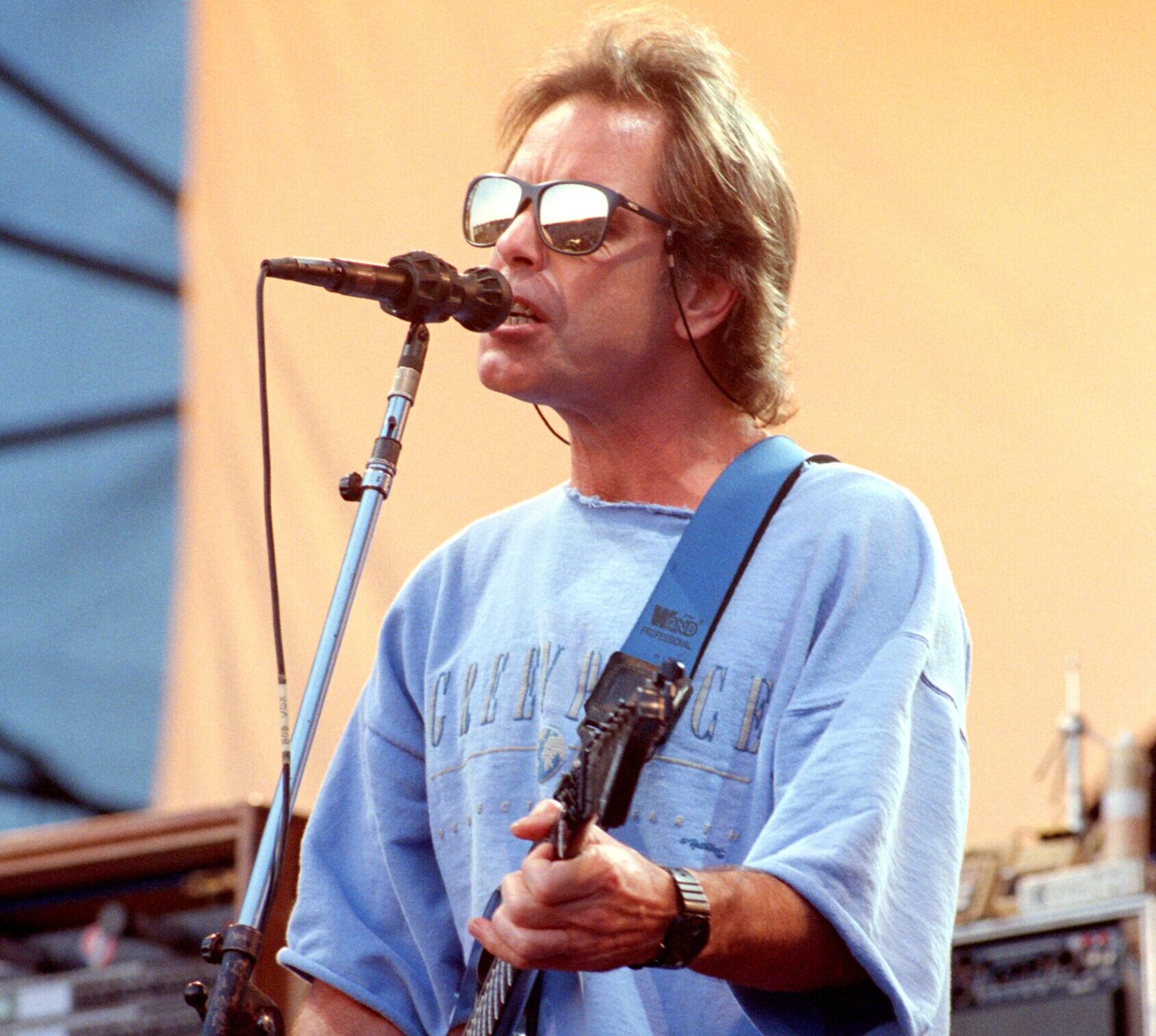 Bob Weir of the Grateful Dead performing on guitar and singing into a microphone.