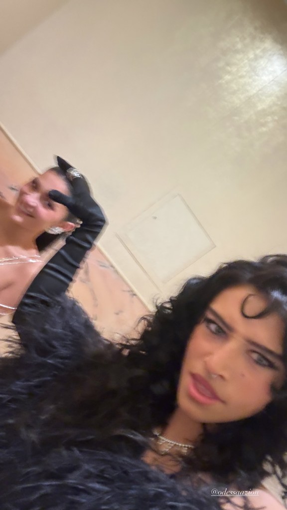 Kylie Jenner laughs as Odessa A'zion reaches toward her head in a candid selfie.