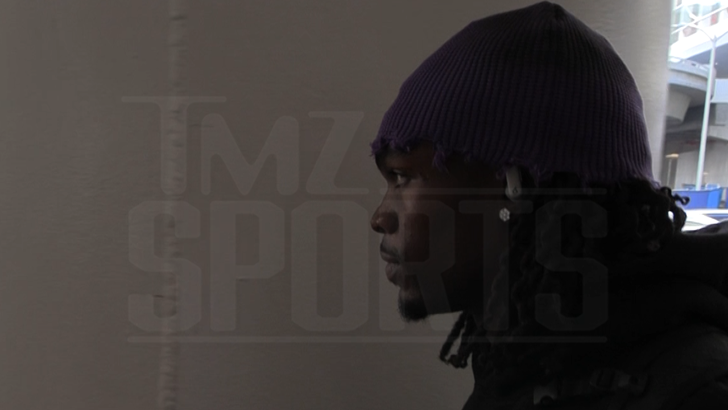 Rashee Rice at LAX on Jan. 28, 2026, wearing a purple hat and black sweatshirt, declining to answer questions about recent allegations.