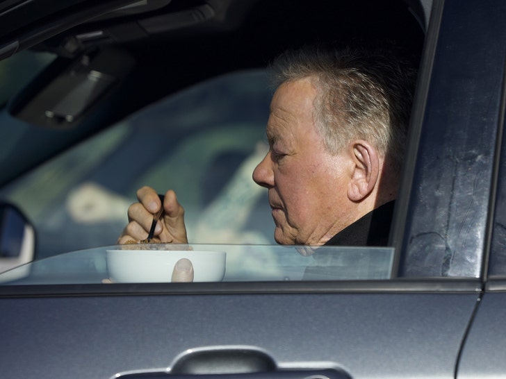 William Shatner posing in a car holding a bowl of cereal during a Kellogg's Super Bowl commercial shoot.