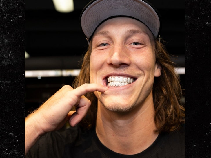 Trevor Lawrence flashes a diamond grill in the Jaguars' locker room after a 41-7 win over the Titans.