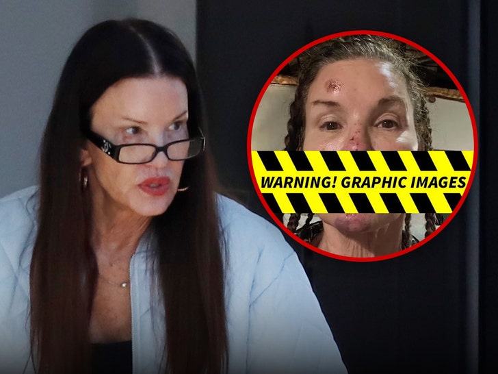 Janice Dickinson smiling in Los Angeles wearing a denim jacket and glasses.