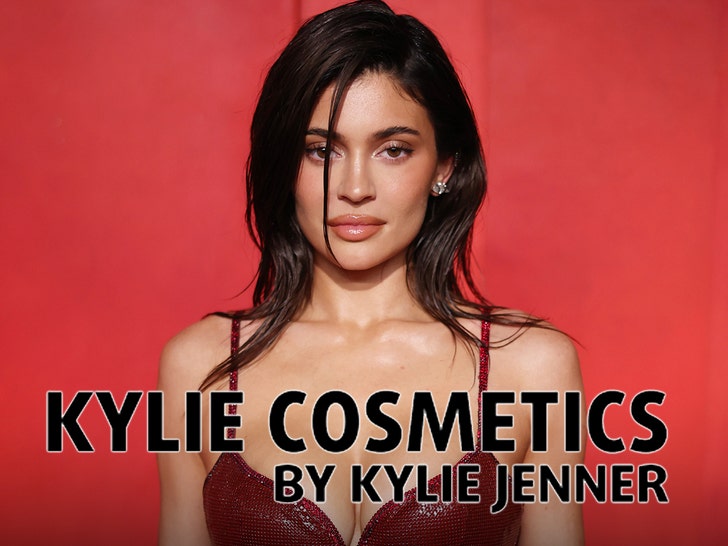 Kylie Jenner promotes COSMIC INTENSE, wearing a red leather top and holding the red perfume bottle against her head