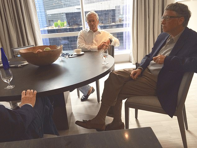 Bill Gates seated with Jeffrey Epstein and others at a table in an undated image released with recent files