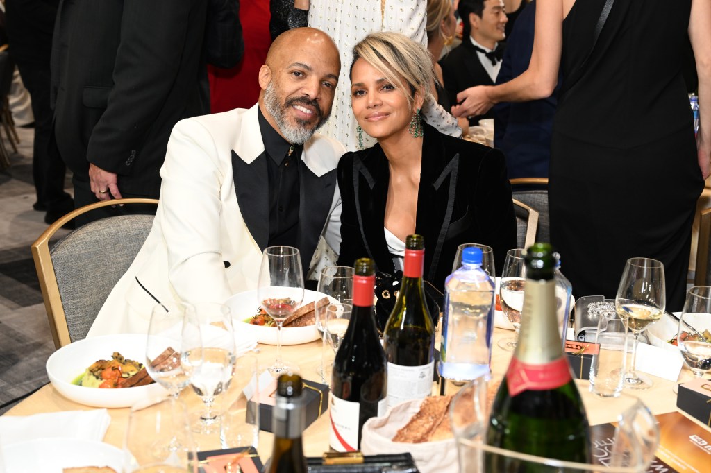 Halle Berry and Van Hunt seated together at a formal dinner event.